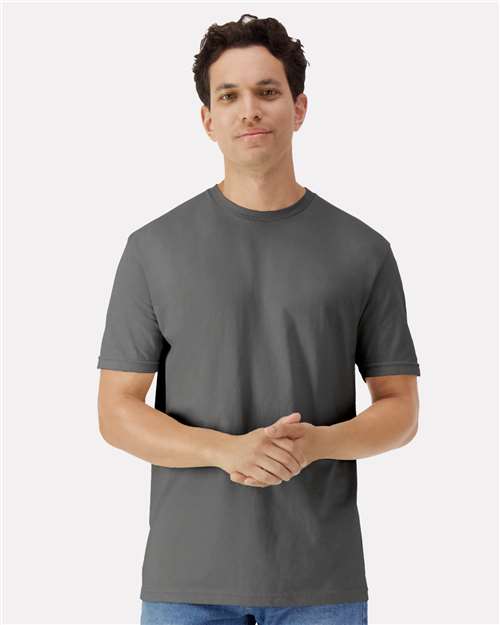 Man wearing a gray t-shirt against a white background